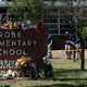 FILE - Investigators search for evidences outside Robb Elementary School in Uvalde, Texas, May 25, 2022, after an 18-year-old gunman killed 19 students and two teachers. Uvalde Consolidated Independent School District Police Chief Pete Arredondo, who served as on-site commander during the shooting, said that he's talking daily with investigators, contradicting claims from state law enforcement that he has stopped cooperating. (AP Photo/Jae C. Hong, File)